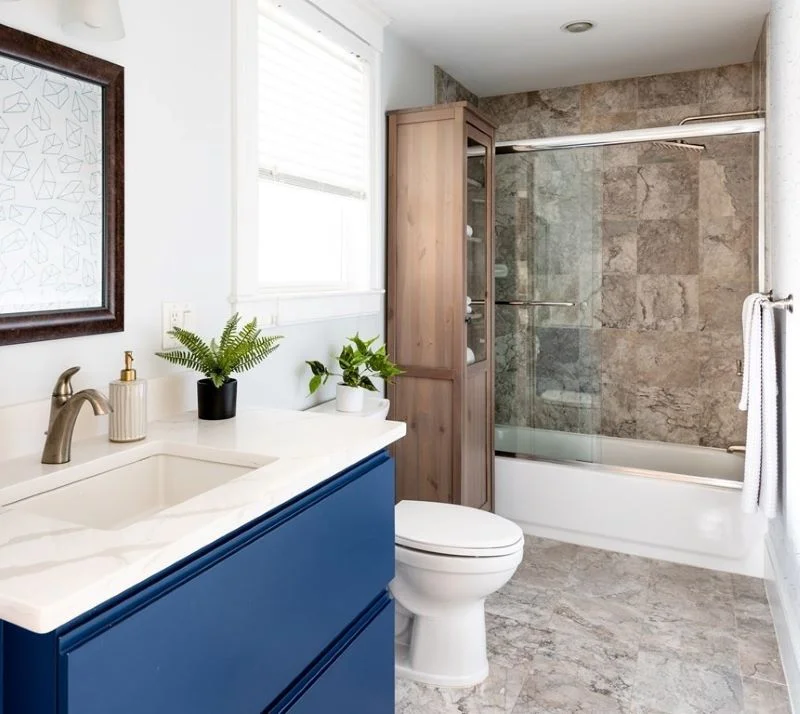 Custom 3-drawer bathroom sink vanity in painted blue, with dovetailed maple drawers on Blum Movento hardware and a locking, pull-out step stool for kids.